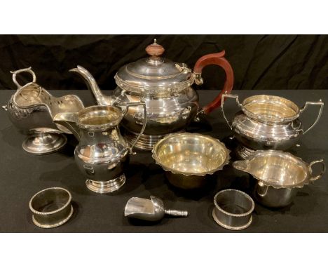 An early 20th century silver plated three piece tea service, scroll handles, the teapot, 15cm high, marked EPNS A1; a Victori