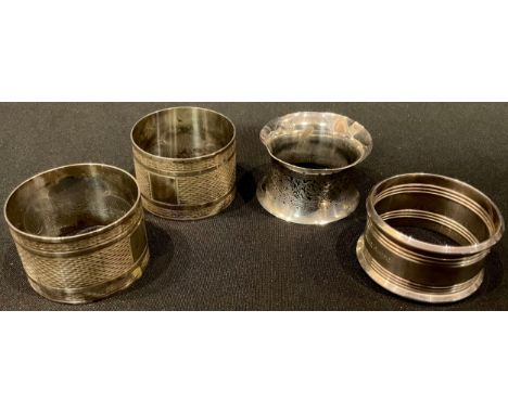 A pair of George V silver engine turned napkins, Sheffield 1932, cased; two other silver napkin rings, 95.9g 