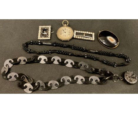 A late 19th century oval polished agate brooch; a buckle set with paste stones; another; a lady's silver open face pocket wat