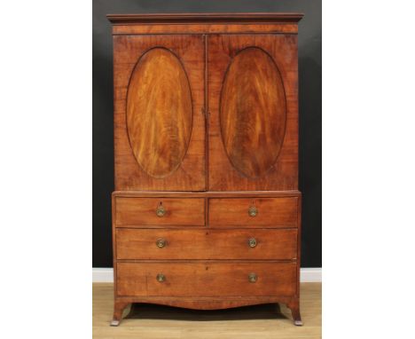 A George III mahogany hanging press cupboard, formerly a linen press, outswept cornice above a pair of panel doors enclosing 