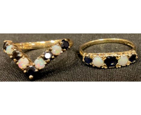 A 9ct gold sapphire and opal wishbone ring, size Q, 3g; a 9ct gold five stone graduated sapphire and opal ring, size P, 1.6g 