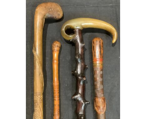 Walking Sticks - a Folk Art walking stick, the staff carved with a coiled snake and snakes head; other Folk Art type sticks (