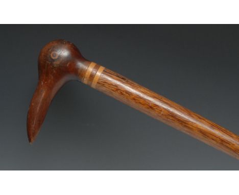 A Pitcairn Island walking stick, the pommel carved as the head of a bird, the cane 85.5cm long overall 