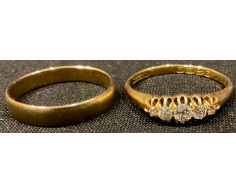 An 18ct gold ring, set with five graduated bright cut stones, size P, 2.1g; a 9ct gold wedding band, size M, 1.56g (2) 