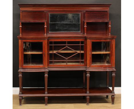 An Edwardian mahogany drawing room cabinet, the superstructure centred by a bevelled rectangular mirror flanked by shaped she