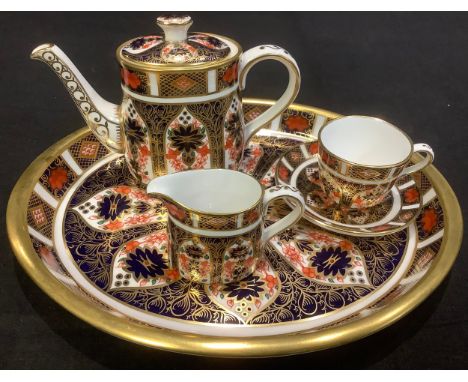 A Royal Crown Derby 1128 pattern miniature part tea set on tray comprising teapot, cream jug, oval tray, tea cup and saucer, 