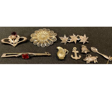 A sterling silver thistle brooch, set with an amethyst, 3.5cm; a silver leaf brooch; a silver filigree brooch; a silver pig c