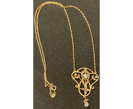 A late 19th/early 20th century 9ct gold Belle Epoch style pendant necklace, the open work pendant set with faceted aquamarine