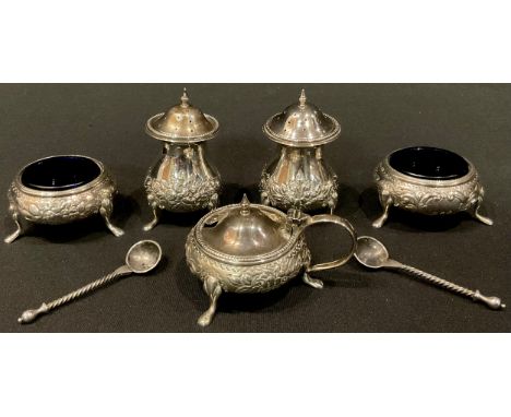 A George V silver five piece cruet set, comprising a pair of pepper, pair of open table salts with blue glass liners, mustard