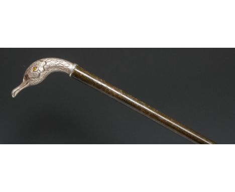 An early 20th century silver coloured metal mounted novelty walking stick, the handle as the head of a duck, glass eyes, hard