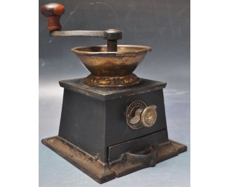 An early 20th century cast iron T &amp; C clark Wolverhampton coffee mill grinder having a wooden handle with brass plaque to