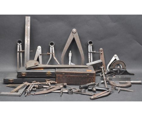 A collection of vintage retro mid 20th century engineer measuring tools to include micrometers, rulers, levels, compass, and 