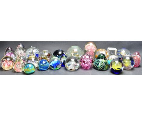A collection of 20th century glass paperweights including some with cane work, bubble control as well as some Mdina and Orref
