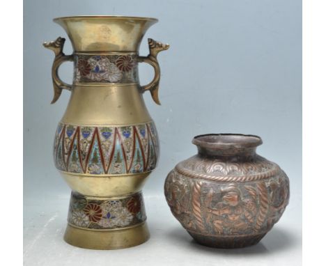 An early 20th century Chinese brass and enamel vase having a waisted neck, twin zoomorphic handles and geometric polychrome d