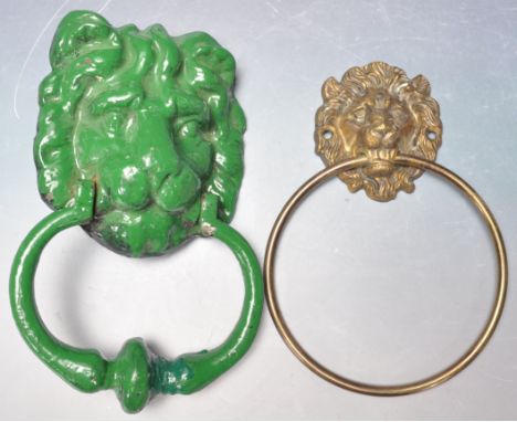 A 19th century Victorian cast iron lion head door knocker of a large form with swing ring to the lower part insisted in green