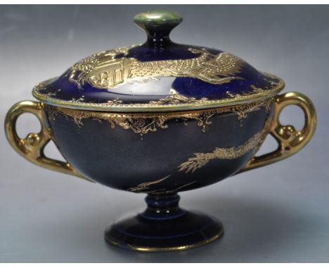 A 19th century Chinese oriental ceramic porcelain twin handle lidded cup. The cups being decorated with gild dragons motifs o