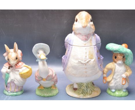 A group of four 20th century vintage Beatrix Potter ceramic figurines to include a Royal Albert Mrs Rabbit and Benjamin Bunny