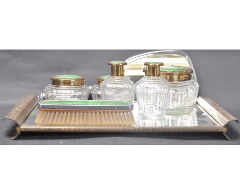 An early 20th century Art Deco silver plate dressing table set having guilloche enamel decoration. The dressing table set com
