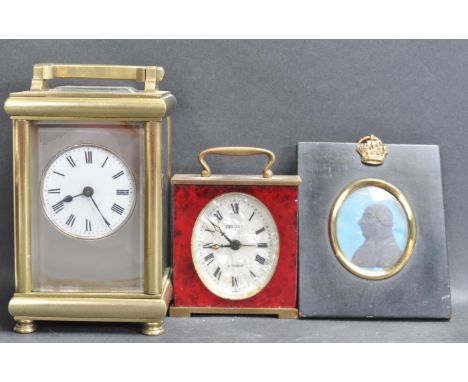 Two vintage 20th century brass carriage clocks one having a red stone facade and the other having glass sides with a carry ha