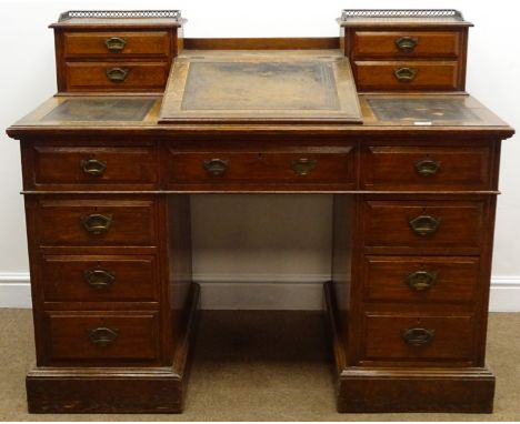 Victorian oak double pedestal desk, hinged sloped leather inset writing pads and two trinket drawers above nine drawers, plin