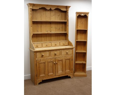 Traditional pine dresser with twin shelf back , four short and three long drawers above two panelled doors, solid end support