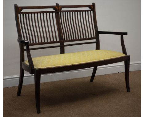 Edwardian inlaid mahogany two seat settee, shaped stick back and upholstered seat, square tapering supports, W121cm