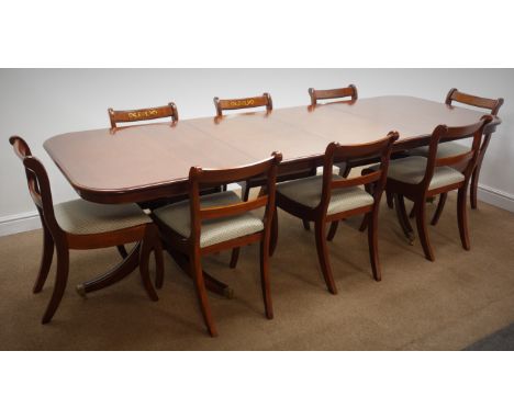 Regency style mahogany twin pillar dining table, with two leaves, moulded top, turned columns, splayed supports with brass ca