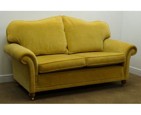 Three seat sofa upholstered in a golden fabric, turned supports (W215cm) and a matching two seat sofa (W190cm)