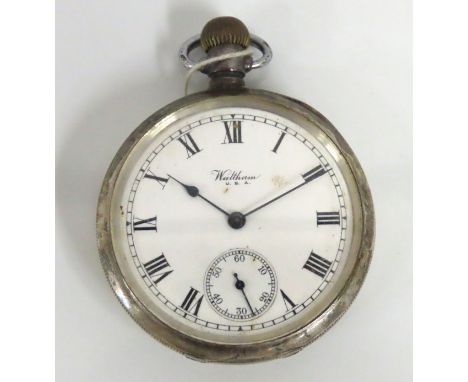 A silver Waltham pocket watch with Dennison case, winds & runs although time setting mechanism a little rough, 50mm case diam