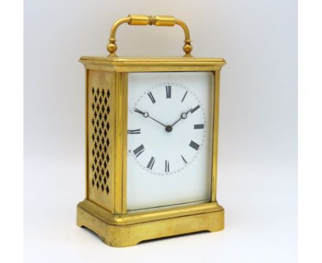 A brass carriage clock with fretwork panels to side, 158mm high inclusive, winds & runs