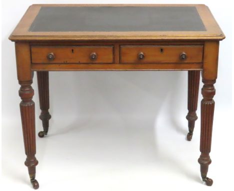 A compact Victorian leather topped walnut two drawer desk with gadrooned legs, 920mm wide x 600mm deep x 745mm high