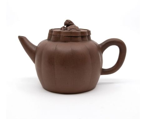 A Yixing Teapot and Cover of Melon form, the cover with a recumbent lion finial. Impressed mark.Date: 19th century or laterSi