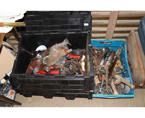 Two plastic crates containing various hand tools to include saws, hand braces, oil guns, a trailers ball hitch, grease guns e