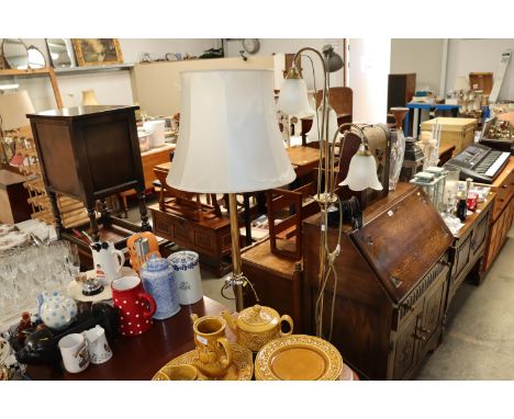 A three branch standard lamp together with a brass standard lamp and shade