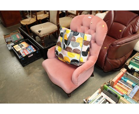 A pink button down upholstered chair 