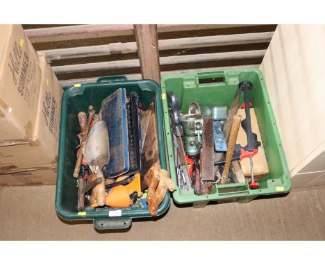 Two plastic crates containing various hand tools to include saws, trowels, part socket set, bottle jacks etc. 
