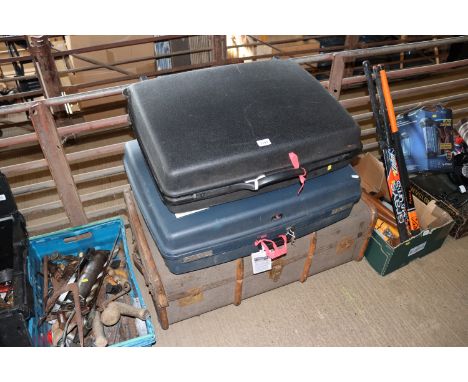 Two plastic suitcases; and a canvas and wooden bound travelling trunk