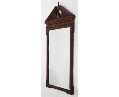 A YEW WOOD HANGING WALL MIRROR with architectural crest and bevelled mirror plate, 49cm wide x 92cm high