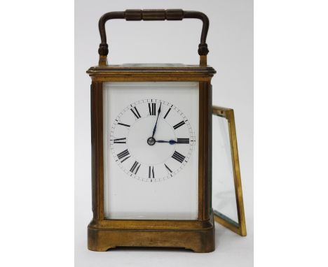 A FRENCH BRASS CARRIAGE CLOCK, the enamel dial with Roman numerals, the movement striking the hours and half hours on a gong,