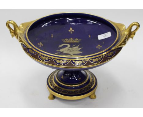 A BLUE GLAZED FRENCH PORCELAIN TAZZA with gilt decoration and swan handles, centrally decorated with a swan crest pierced wit