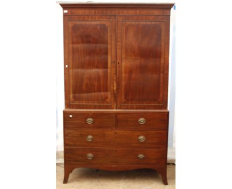 A VICTORIAN MAHOGANY LINEN PRESS with two panelled door, opening to reveal four linen drawers above two short and two long dr