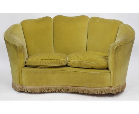A 1930'S GREEN TWO SEATER TUB STYLE SOFA with tasselled edges 148cm wide 