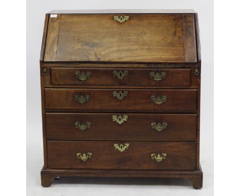 A GEORGE III MAHOGANY BUREAU, the fall front enclosing a fitted interior over four long drawers and standing on bracket feet,