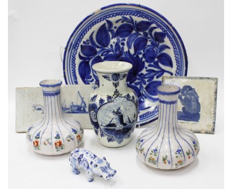 TWO ANTIQUE BLUE AND WHITE DELFT TILES each 13cm squared, a further blue and white tile, a blue and white tin glazed charger 