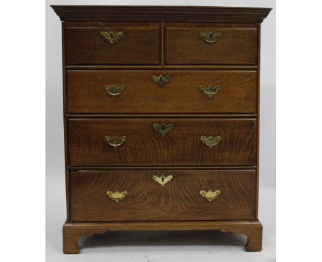 AN ANTIQUE OAK CHEST OF TWO SHORT AND THREE LONG DRAWERS, all standing on bracket feet, 100.5cm wide x 117cm high