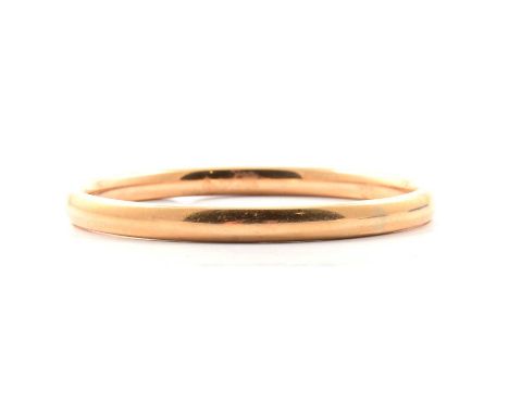 A yellow metal slave bangle, 6.5mm wide, plain polished finish, internal diameter 6.5cm, 44g.