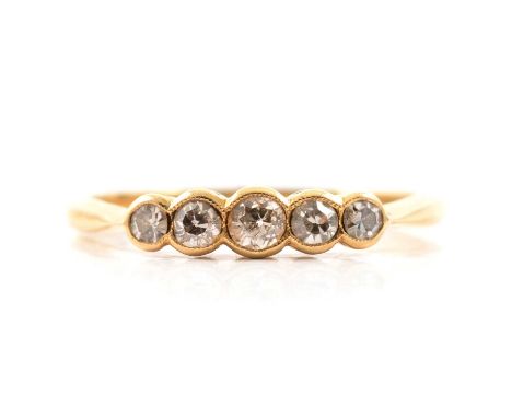 A diamond five stone ring, the old cut stones graduating in size, millegrain set in an all yellow metal mount ring size O, gr