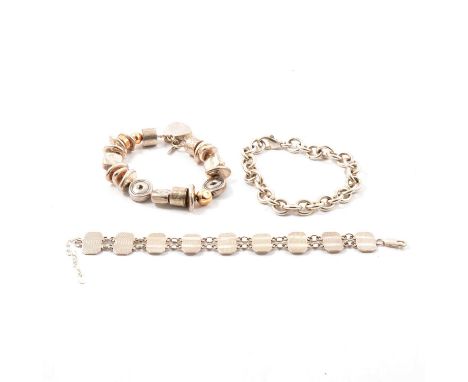 Three silver bracelets, a solid 11mm gauge oval link chain bracelet hallmarked London 2014; a "Silver" bracelet formed from n