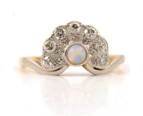 An opal and diamond fan shaped ring, the 3mm round cabochon cut opal millegrain set surmounted by a fan of fourteen brilliant