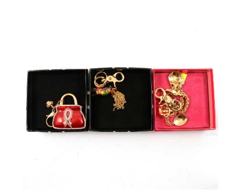 Three Butler &amp; Wilson enamel and diamante keyrings in branded boxes, a 60mm red enamel gilt metal handbag with diamante b